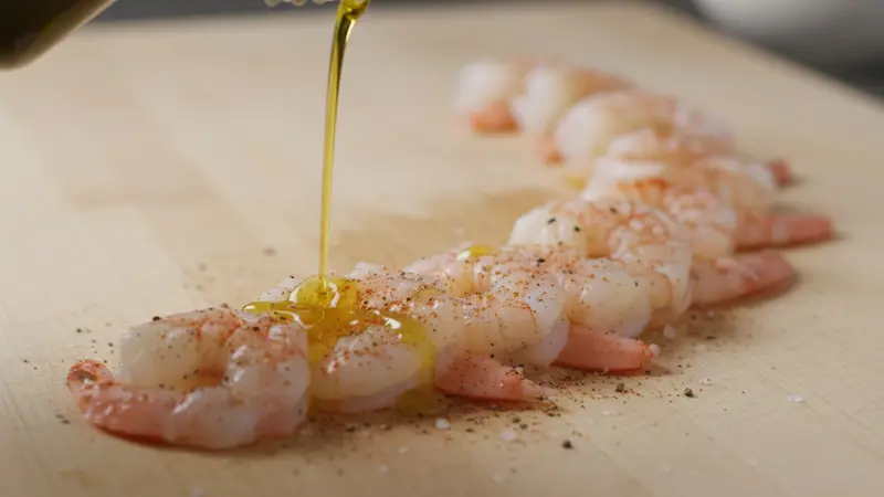 Season and briefly marinate the shrimp