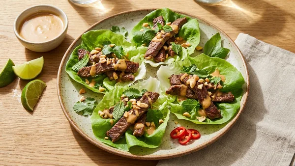 Thai Ginger Beef Lettuce Wraps with Crunchy Herbs and Peanut-Lime Dressing