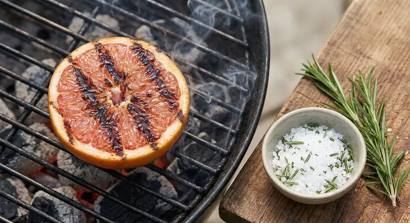 Prep grill and make smoked-rosemary salt; char grapefruit halves